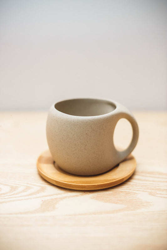 Ceramic teacup and wooden saucer